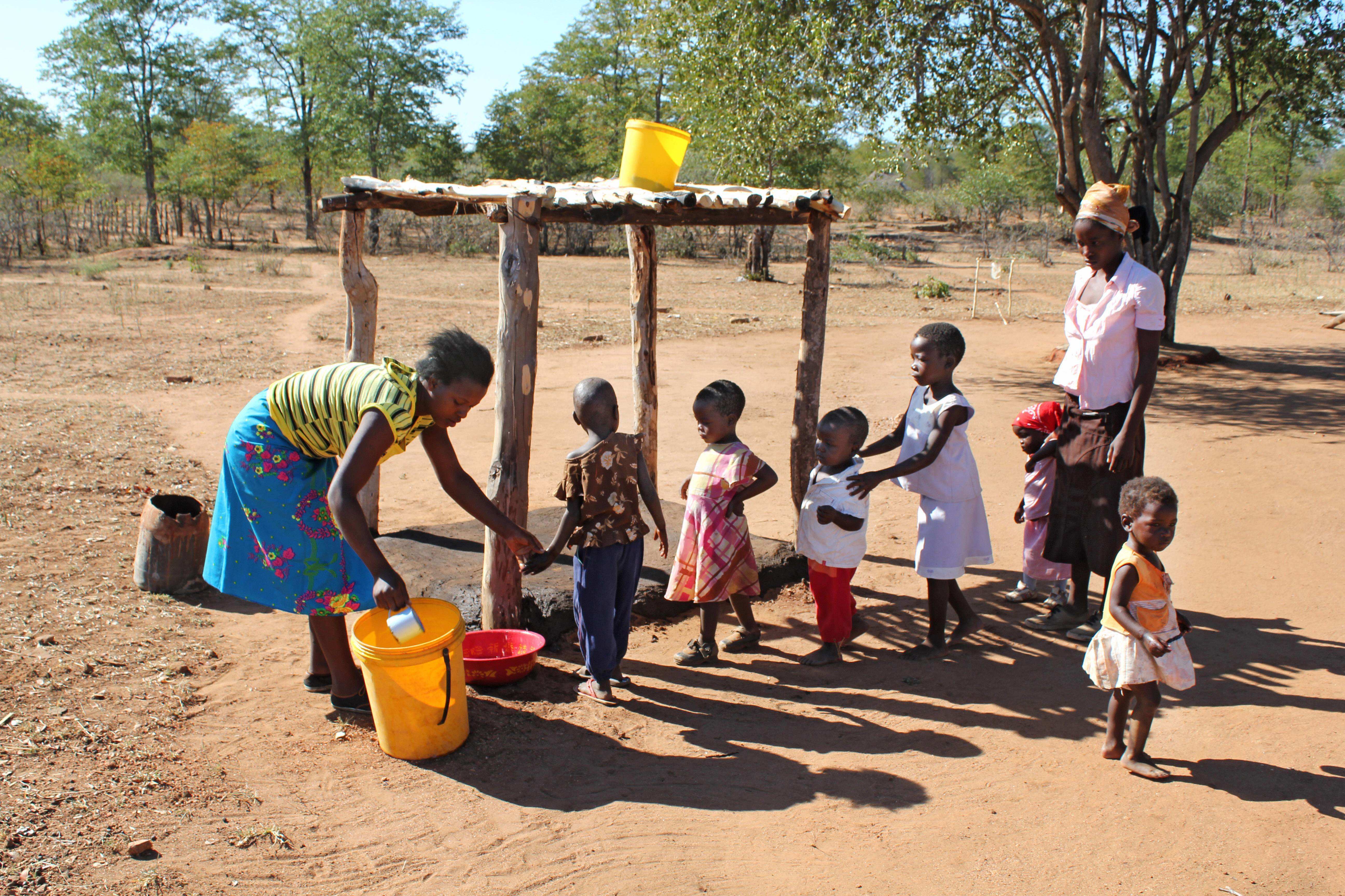 Kinder einer Familie in Simbabwe bekommen Wasser, Foto: imago0059718204h Kinder einer Familie in Simbabwe bekommen Wasser, Foto: imago0059718204h